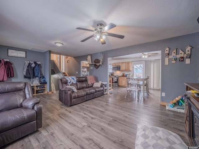 347 Copper, Evansville, WY 82636 - living room with baseboards, a textured ceiling, a ceiling fan, and wood finished floors