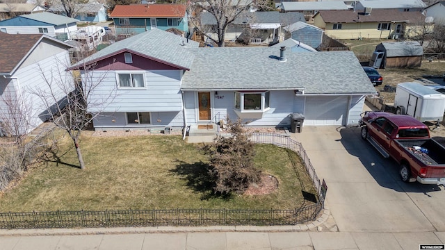 347 Copper, Evansville, WY 82636 - view of front of house featuring a shingled roof, a residential view, fence private yard, concrete driveway, and an attached garage