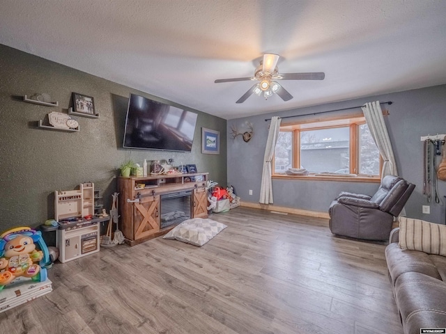347 Copper, Evansville, WY 82636 - living area with a textured ceiling, baseboards, a ceiling fan, and wood finished floors