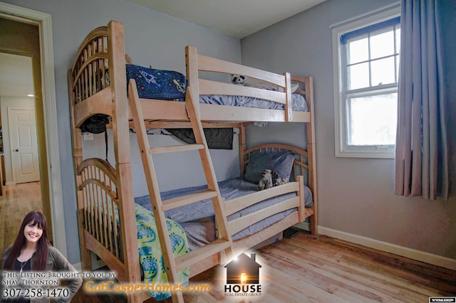 bedroom featuring baseboards and wood finished floors