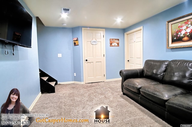 carpeted living area featuring baseboards