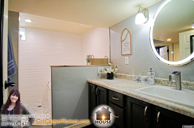 bathroom featuring vanity and a walk in shower