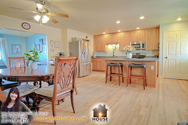 dining room with a ceiling fan, recessed lighting, and light wood-type flooring