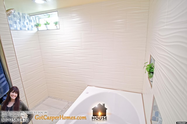 full bath featuring a bath, tile walls, and a shower