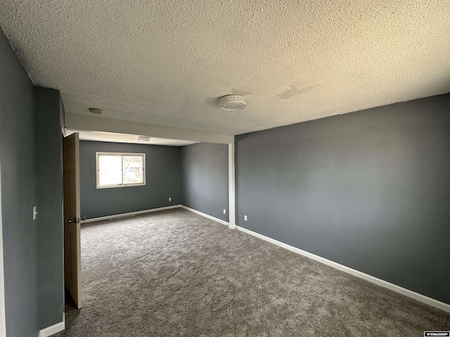 3649 Campbell Dr, Torrington, WY 82240 - carpeted empty room featuring baseboards and a textured ceiling