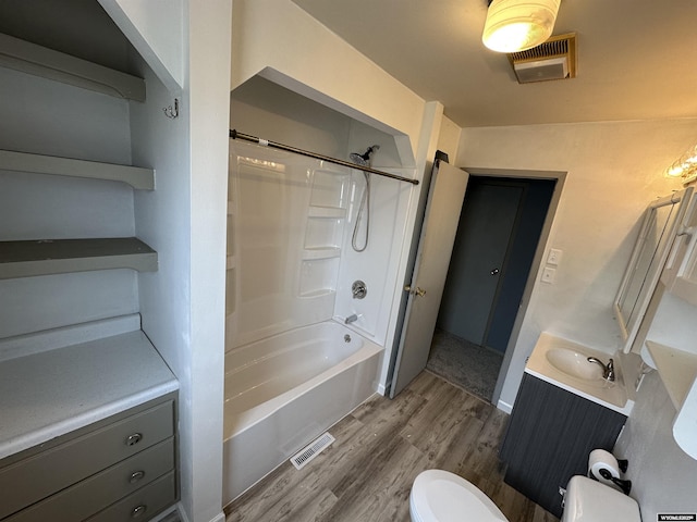 3649 Campbell Dr, Torrington, WY 82240 - full bath with tub / shower combination, visible vents, toilet, wood finished floors, and vanity