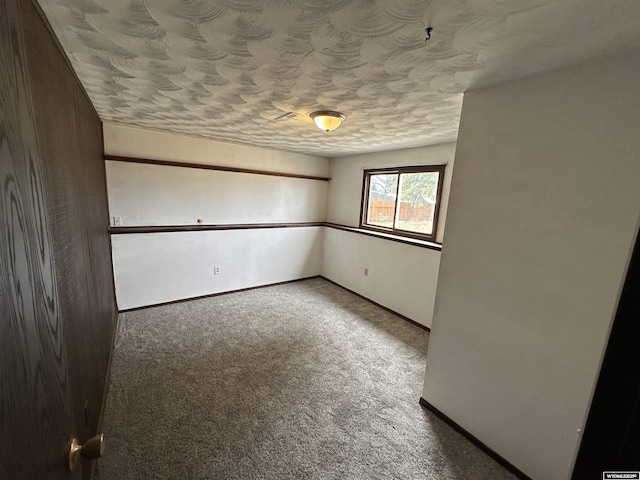 3649 Campbell Dr, Torrington, WY 82240 - spare room with baseboards, carpet, and a textured ceiling