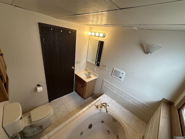 3649 Campbell Dr, Torrington, WY 82240 - bathroom featuring vanity, toilet, a drop ceiling, tile patterned floors, and a jetted tub