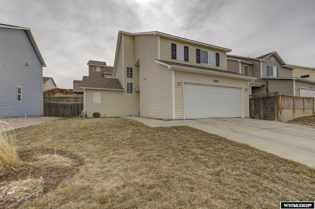 view of front of property with fence, driveway, a front yard, and a garage