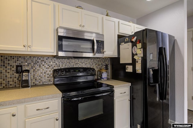 kitchen with decorative backsplash, light countertops, white cabinetry, and black appliances
