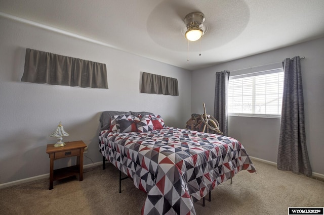 bedroom featuring baseboards, carpet floors, and ceiling fan