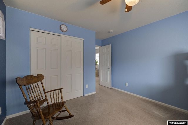 living area featuring carpet floors, a ceiling fan, and baseboards