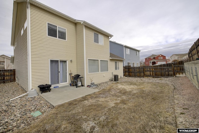 back of property with a patio area and a fenced backyard