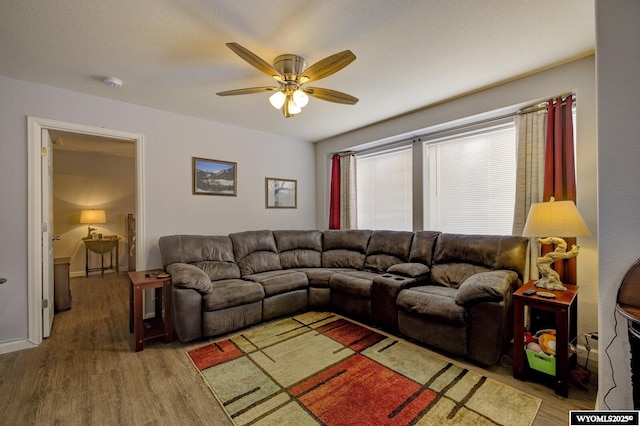 living room with ceiling fan and light wood finished floors