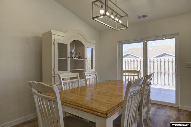 2087 Basswood St, Casper, WY 82604 - dining space featuring vaulted ceiling, baseboards, visible vents, a notable chandelier, and wood finished floors