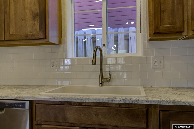 2087 Basswood St, Casper, WY 82604 - kitchen featuring light countertops, a sink, stainless steel dishwasher, and tasteful backsplash