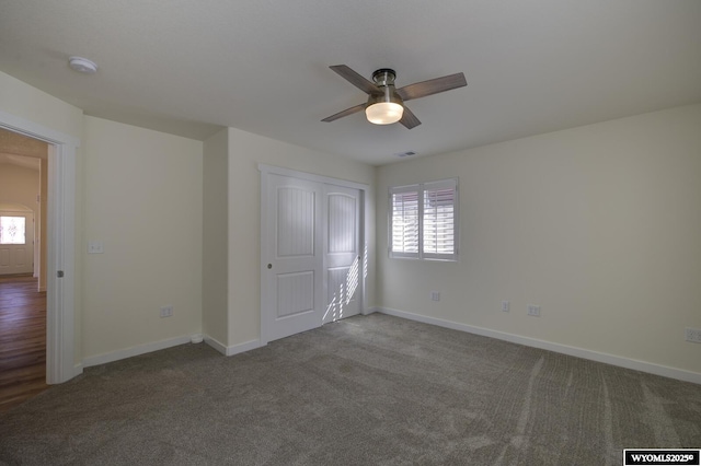 2087 Basswood St, Casper, WY 82604 - unfurnished bedroom with baseboards, a closet, carpet, and a ceiling fan