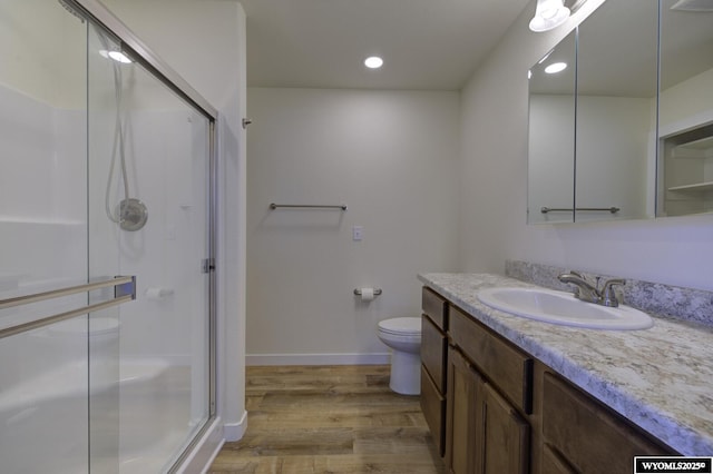 2087 Basswood St, Casper, WY 82604 - bathroom with vanity, toilet, baseboards, a stall shower, and wood finished floors