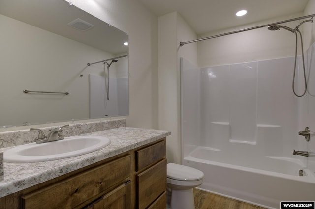 2087 Basswood St, Casper, WY 82604 - bathroom with vanity, toilet, tub / shower combination, visible vents, and wood finished floors