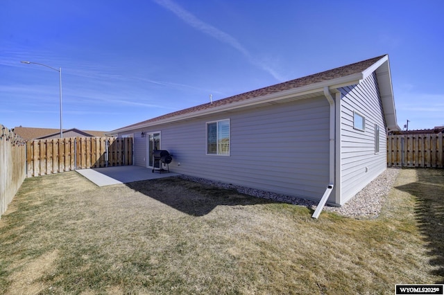 2087 Basswood St, Casper, WY 82604 - back of property featuring a fenced backyard, a yard, and a patio area