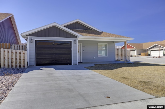 2087 Basswood St, Casper, WY 82604 - ranch-style house featuring fence, a garage, concrete driveway, a front yard, and roof with shingles