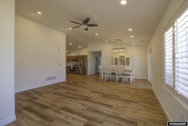 2087 Basswood St, Casper, WY 82604 - unfurnished dining area with vaulted ceiling, recessed lighting, visible vents, a ceiling fan, and wood finished floors