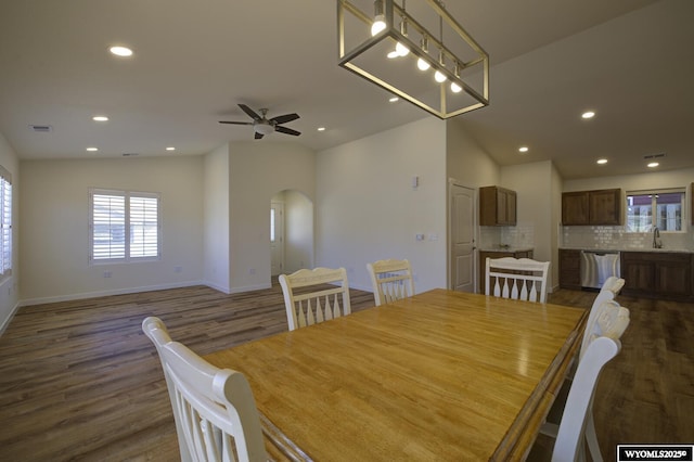 2087 Basswood St, Casper, WY 82604 - dining area with arched walkways, dark wood-style flooring, a wealth of natural light, and visible vents