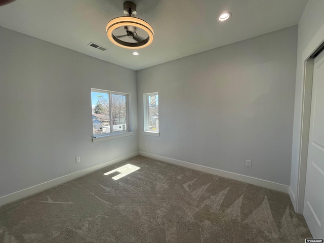 carpeted spare room with recessed lighting, visible vents, baseboards, and ceiling fan