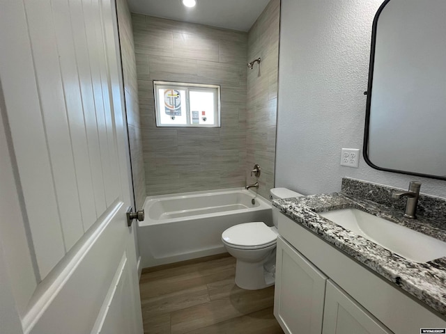 bathroom with wood finished floors, vanity, shower / tub combination, toilet, and recessed lighting