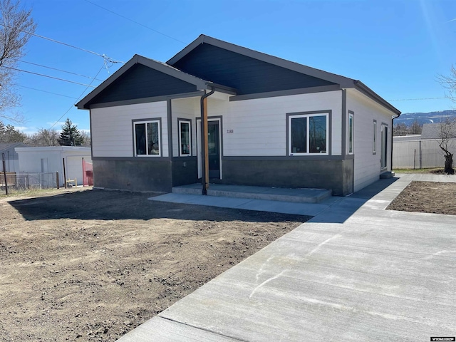 ranch-style home featuring fence