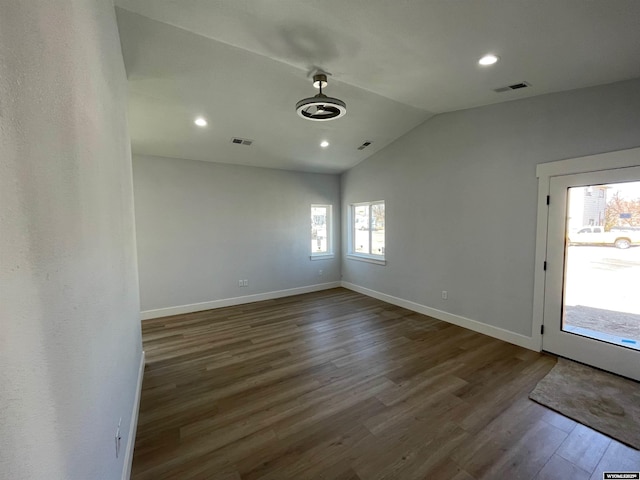interior space with lofted ceiling, visible vents, baseboards, and wood finished floors