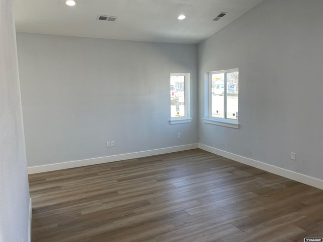 spare room featuring wood finished floors, visible vents, and recessed lighting