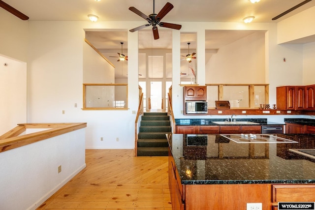 94 Upper Clear Creek Rd, Buffalo, WY 82834 - kitchen featuring high vaulted ceiling, white electric stovetop, ceiling fan, stainless steel microwave, and a sink
