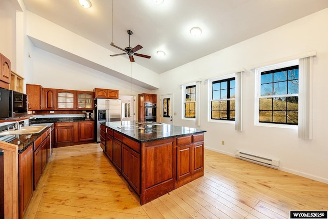 94 Upper Clear Creek Rd, Buffalo, WY 82834 - kitchen with a kitchen island, stainless steel fridge, a baseboard radiator, light wood-style flooring, and ceiling fan