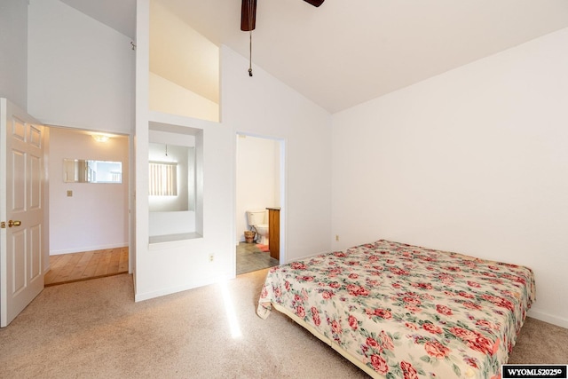 94 Upper Clear Creek Rd, Buffalo, WY 82834 - carpeted bedroom featuring high vaulted ceiling, a ceiling fan, and connected bathroom