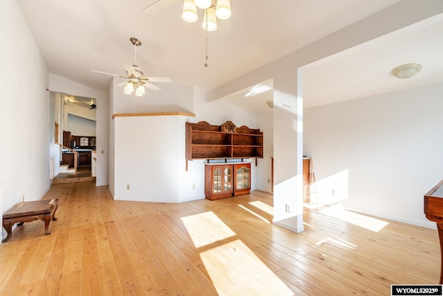 94 Upper Clear Creek Rd, Buffalo, WY 82834 - unfurnished living room featuring baseboards, lofted ceiling, a ceiling fan, and light wood finished floors