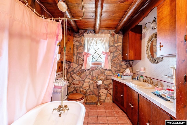 bathroom featuring tile patterned flooring, vanity, a freestanding tub, wood ceiling, and beam ceiling