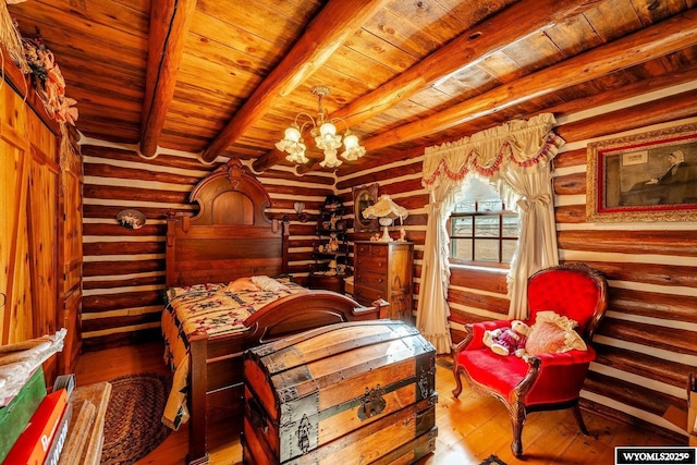 bedroom with beam ceiling, wood ceiling, a chandelier, rustic walls, and hardwood / wood-style floors