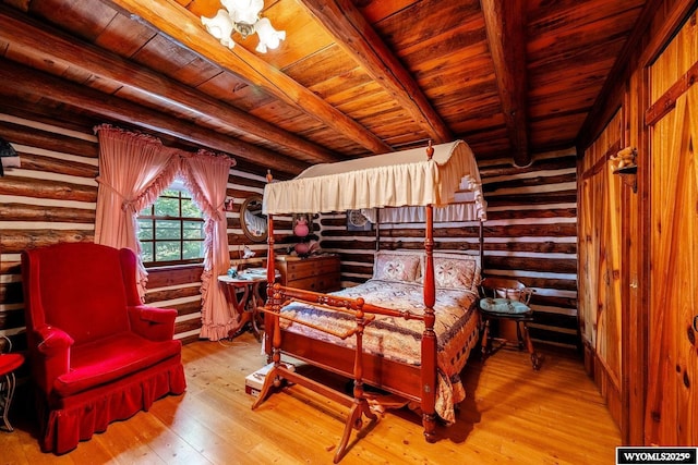 bedroom with beam ceiling, log walls, wood ceiling, and hardwood / wood-style floors