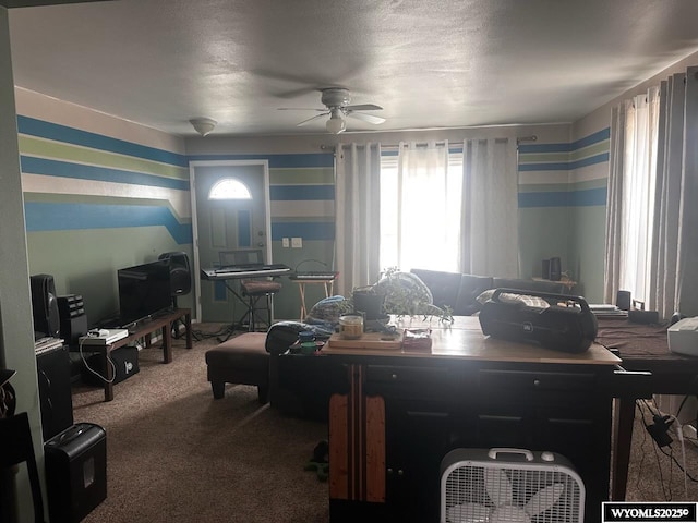 dining space featuring carpet, a textured ceiling, and ceiling fan