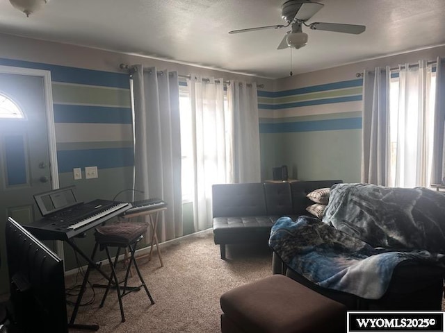 living area with ceiling fan and carpet floors