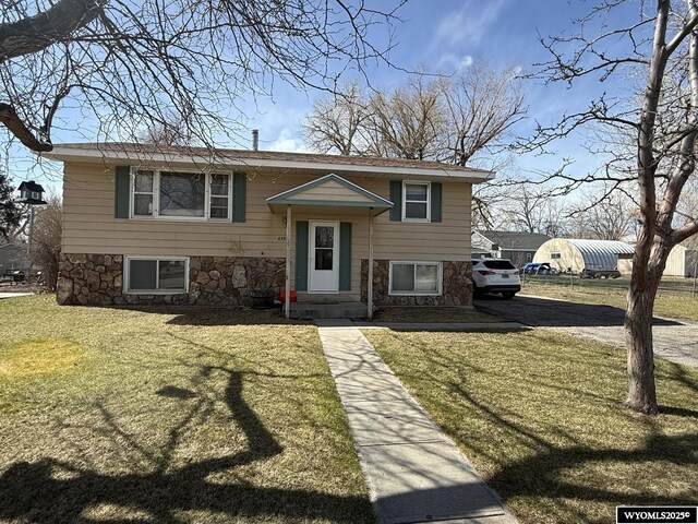 655 Amoretti St, Lander, WY 82520 - bi-level home featuring a front lawn and stone siding
