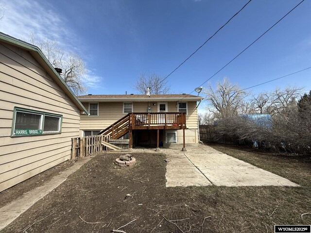 655 Amoretti St, Lander, WY 82520 - back of property with fence, stairway, a deck, and a patio area