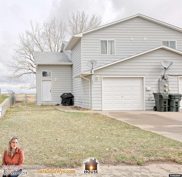 1244 Riverbend Dr, Douglas, WY 82633 - rear view of house with fence, concrete driveway, and a yard
