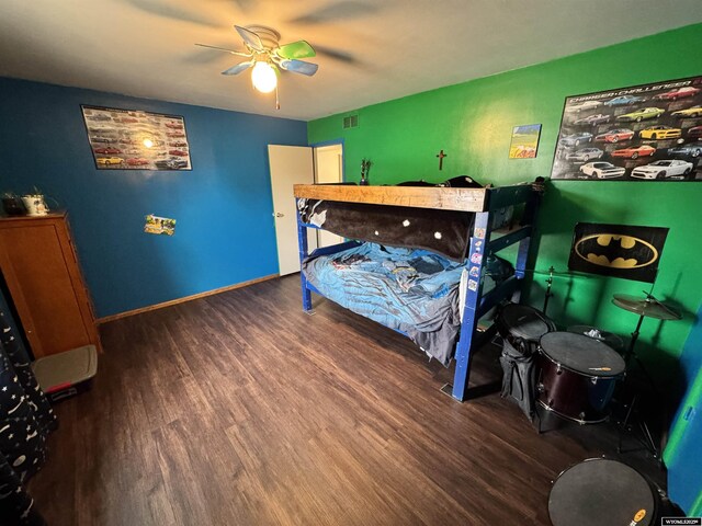 2842 Main St, Torrington, WY 82240 - bedroom with visible vents, baseboards, ceiling fan, and wood finished floors