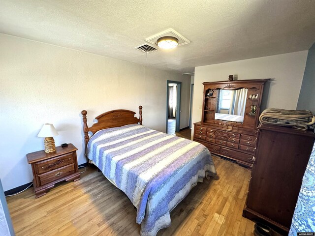 2842 Main St, Torrington, WY 82240 - bedroom with a textured ceiling, light wood finished floors, and visible vents