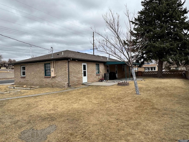 2842 Main St, Torrington, WY 82240 - rear view of property with fence, central air condition unit, a patio, a lawn, and a shingled roof