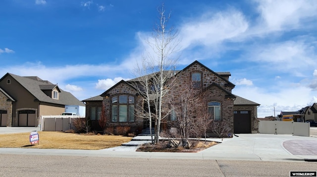 303 Tamarack Dr, Rock Springs, WY 82901 - french provincial home featuring a gate, driveway, fence, and an attached garage