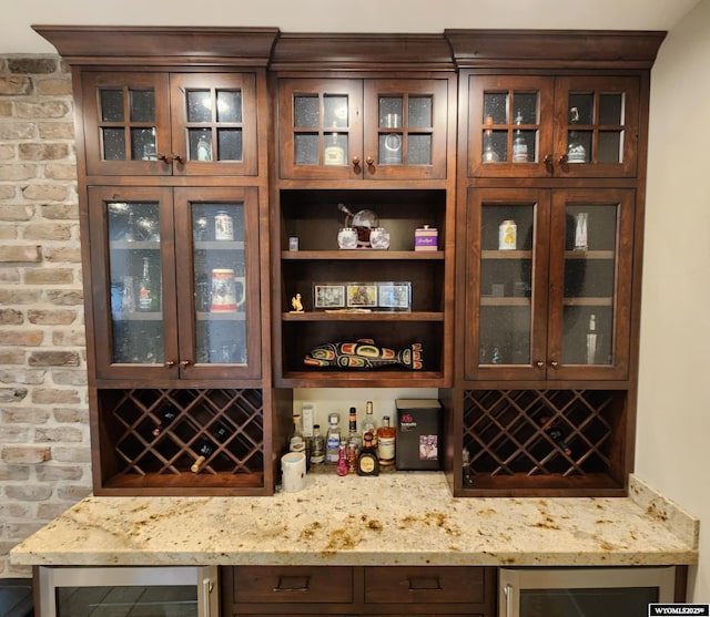 303 Tamarack Dr, Rock Springs, WY 82901 - bar with a bar, brick wall, and wine cooler