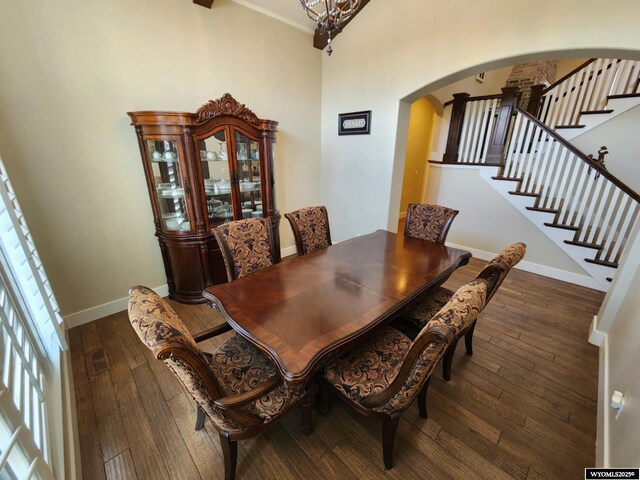 303 Tamarack Dr, Rock Springs, WY 82901 - dining area with baseboards, arched walkways, stairway, and hardwood / wood-style floors